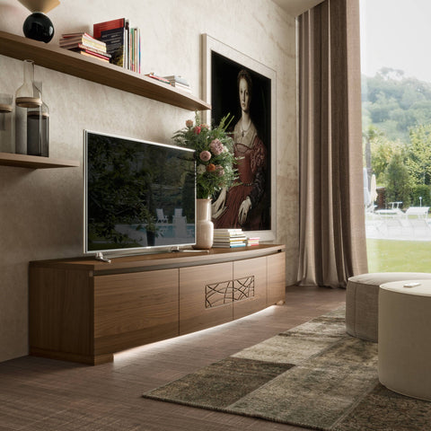 Mobile TV Modigliani 4 porte sagomato in legno di noce con decoro Comete centrale e illuminazione LED integrata, inserito in ambiente living contemporaneo