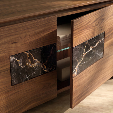 Detailed view of the Modigliani TV cabinet with handcrafted groove opening, Canaletto walnut door, natural marble insert, and interior compartment with glass shelf
